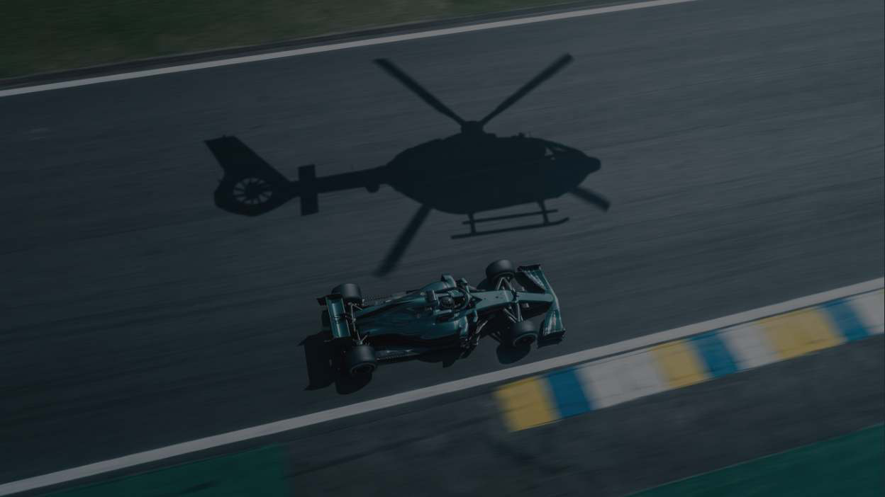 Sombra de helicóptero Revo sobre carro de F1 na pista de Interlagos